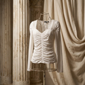 Elegant white long-sleeve top with feminine ruched detailing