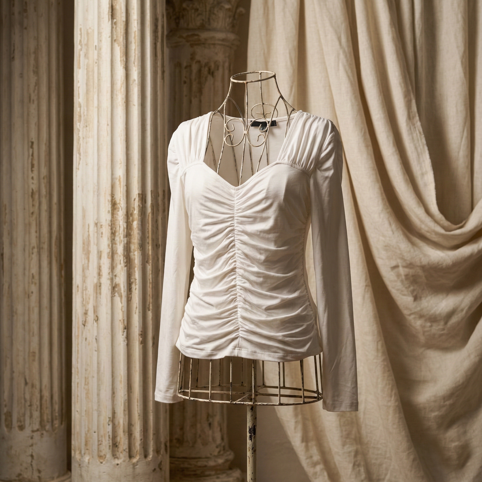 Elegant white long-sleeve top with feminine ruched detailing
