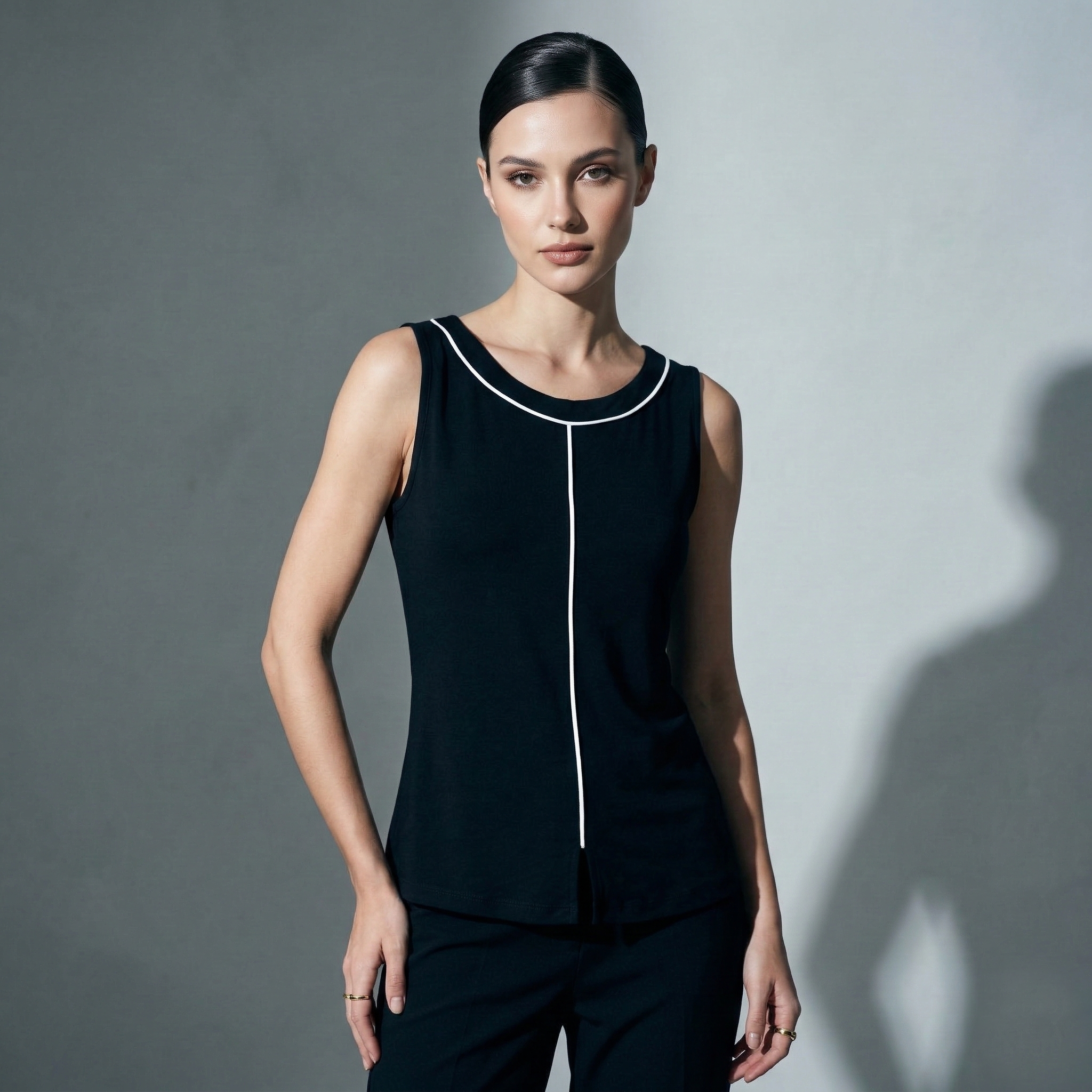 Chic black sleeveless top with white piping detailS