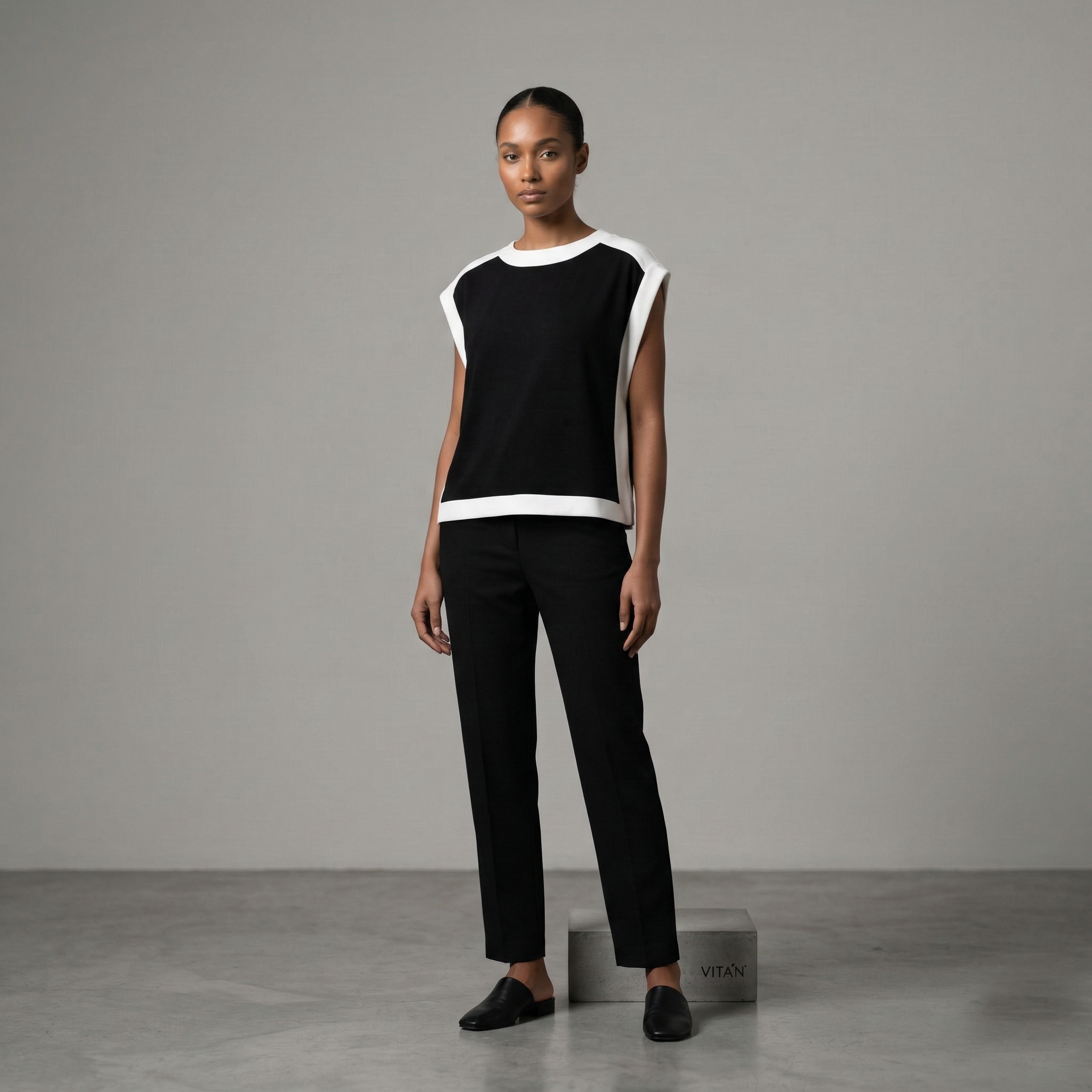 Chic sleeveless black top with contrasting white pane