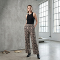 Elegant dark high-waisted wide-leg trousers with an intricate geometric and floral embroidery pattern